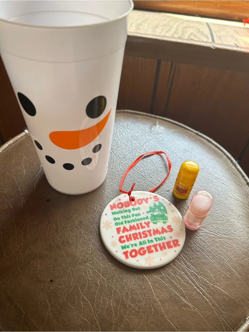 16oz Snowman Cup, 2 pairs of Fuzzy Socks, 2 Lip Balms and Christmas Ornament